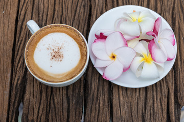 Coffee cup placed on a piece of old wood