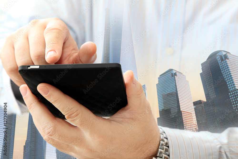 Poster close up of man using smartphone on urban background