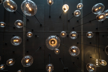 Bottom view of light bulbs background over dark wall