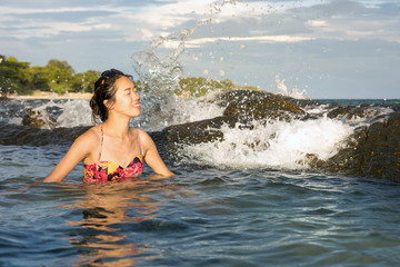 Woman enjoying last sunshine in water