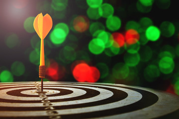 target dart with arrow over blurred Christmas background
