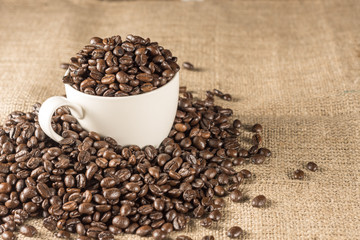 Roasted coffee bean in white cup
