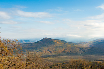 Panoramic view on faraway mountains in fall season