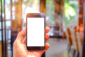 Smart phone in hand with glass blurred background.