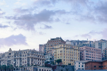 Fototapeta na wymiar Buildings with multitude of architectural styles in the San Teodoro residential district of Genoa, seen from the Piazza Principe railway station in the evening