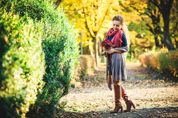 Young beautiful woman at the autumn park.