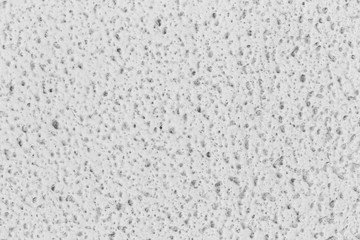 dirty white wall with small pit