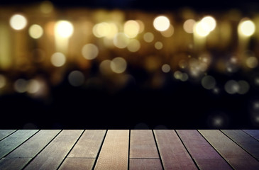 image of wooden table in front of abstract blurred background