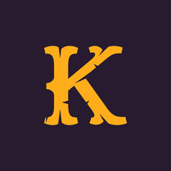 K letter logo. Vintage serif type with rough edges.