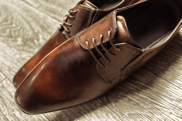 Fashion concept with male shoes on wooden background