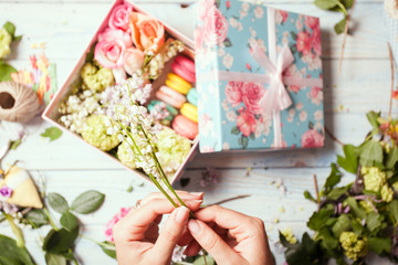 Naklejka na ściany i meble Box with flowers and macaroons