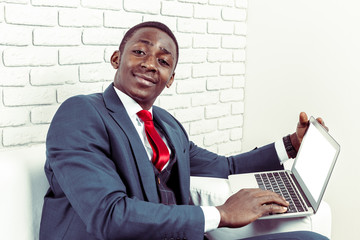 African young man holding laptop