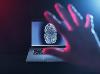 Computer Security, a finger print on a laptop illustrating a personnel password which is about to be hacked