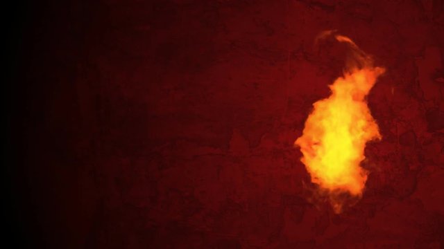 Endlessly burning fire in front of a red grunge background. Seamless loop. Side position.