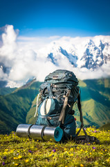 Tourist backpack and sleeping pad on a background of mountains