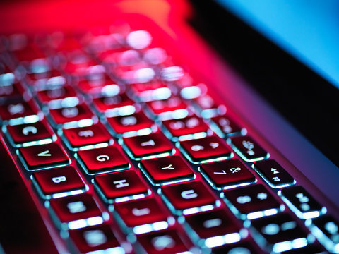 Night-lit laptop computer focusing on the keyboard