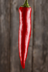 Red pepper on grey board background/Vertical close-up of red pepper