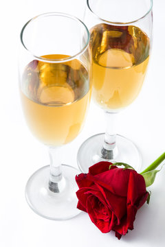 Champagne cups and rose isolated on white background
