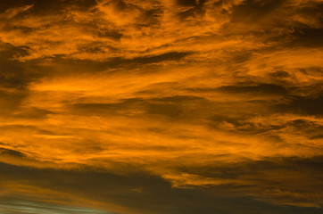 Flowing orange glowing clouds at sunset