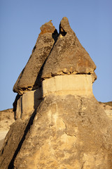 Pointed caps of two fairy chimneys, natural rock formations in Cappadocia, Turkey