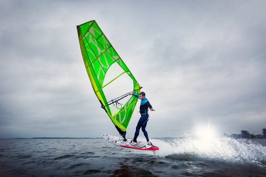 Freestyle windsurfer does a trick on the lagoon