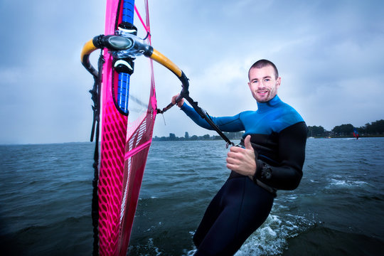 happy windsurfer gives a thumbs up