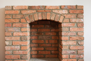 Indoor DIY project: building fireplace in the house: laying bricks; finishing. Selective focus