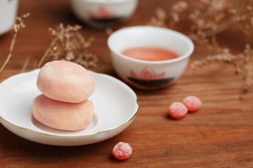 Tasty fruit mochi cakes in white porcelain saucer with chinese c