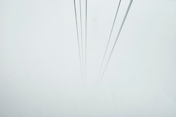 Cable car cables disappearing into mist, Mount Pilatus, Switzerland
