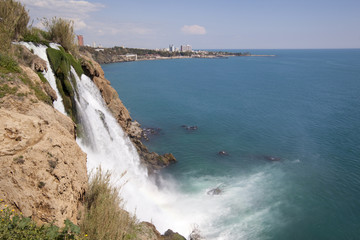 Fototapeta na wymiar Waterfall tumbling off a cliff into the Mediterranean sea in western Turkey