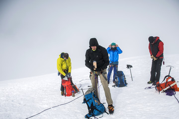 Group Hiking glacier Hvannadalshnukur summit in Iceland mountain landscape Vatnajokull park foggy