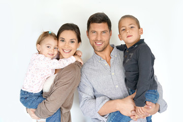Portrait of happy family of four on white background