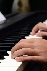 Child hands playing piano