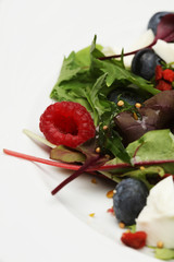 Green salad with arugula and berries, chia, goji