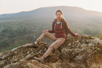 Traveler sitting on top of rock