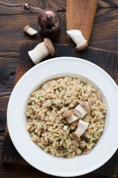 White glass plate with porcini risotto. Above view, close-up