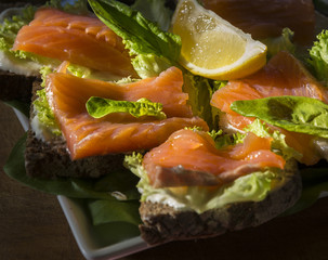 Sandwiches from rye bread with salmon and lemon