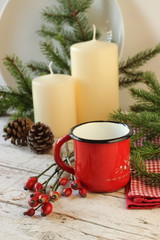 Pentolina rossa e bacche rosse su tavolo