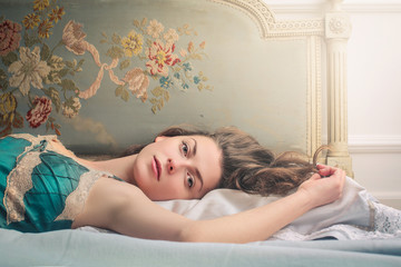 Sensual woman lying in bed
