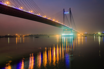 Vidyasagar setu (bridge) on river Hooghly at twilight time in city light illumination. Also known as the Second Hooghly bridge it is the longest cable stayed bridge in India.