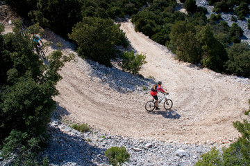 Fototapeta premium Sardinia between mountains and sea - Riding mountain bike