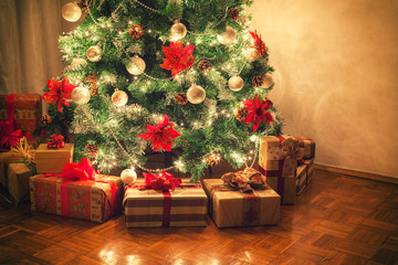 Christmas gifts in front of Christmas tree - 127328732