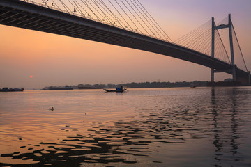 Fototapeta na wymiar Vidyasagar Setu (bridge) on river Hooghly at twilight. The Hooghly bridge is the longest cable stayed bridge in India.
