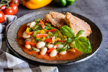 Fried chicken legs with white bean, vegetable and tomato sauce