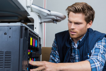 Man servicing photocopier