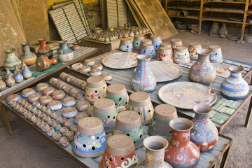 Dozens of recently painted clay ceramic dishes l