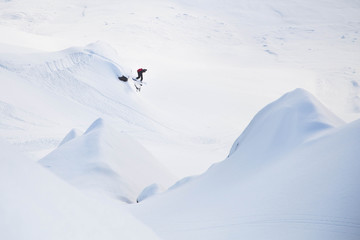 Snow boarder off a cliff