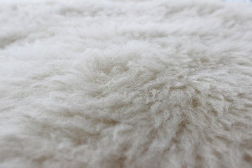 Close up of a white dyed sheepskin rug as a background