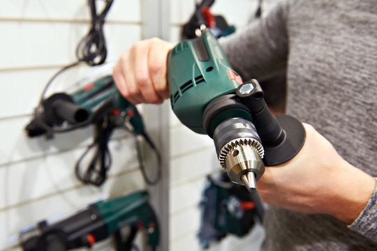 Man with drill in hardware store