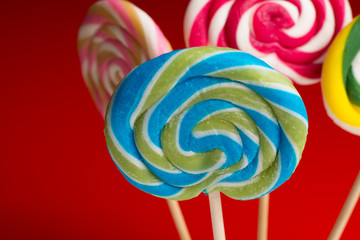 Multicolored sweet candy canes and twirls on wooden sticks